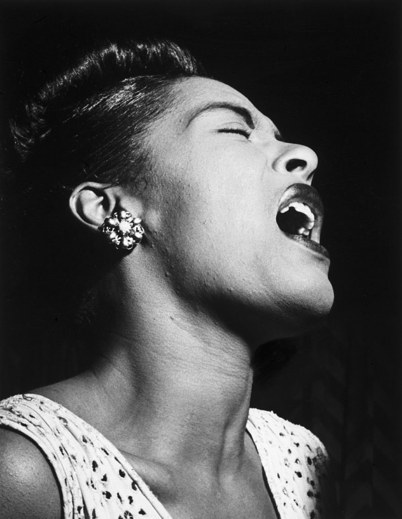 Musician Billie Holiday singing on stage