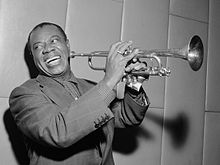 Musician Louis Armstrong playing trumpet