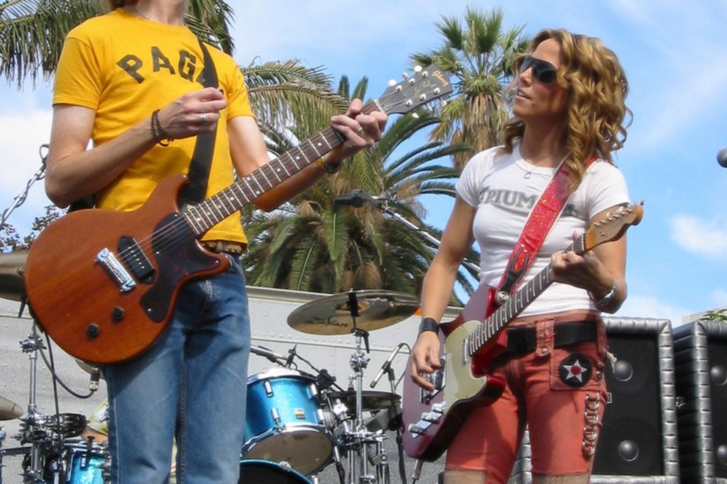 Musician Sheryl Crow on stage with another band member