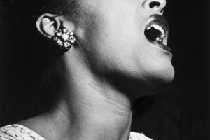 Musician Billie Holiday singing on stage