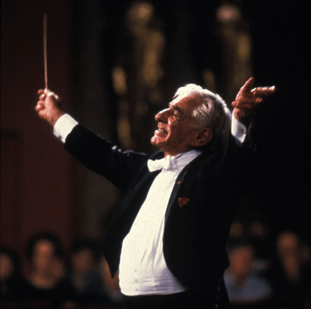 Photograph of Leonard Bernstein conducting an orchestra 