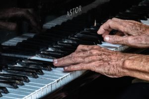 Close up shot of a persons hands playing piano