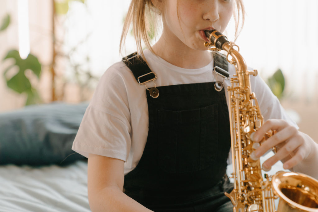 Young girl playing the saxophone